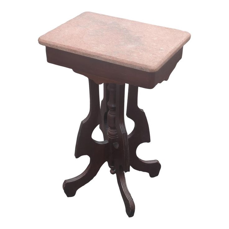 a small wooden table with a marble top on an isolated white background for display or montage