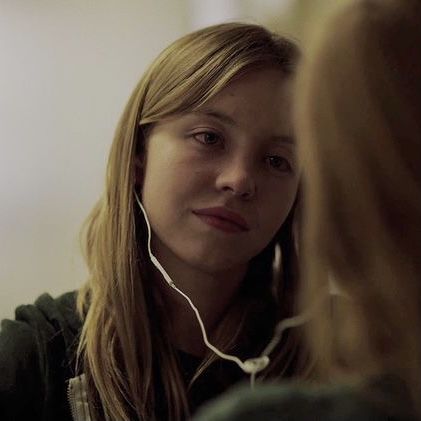 a young woman listening to music with headphones on