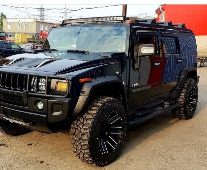 a black hummer truck parked in a parking lot