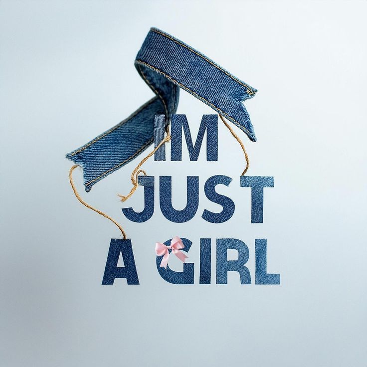 a pair of blue jeans tied to the side of a white wall with text that reads i'm just a girl