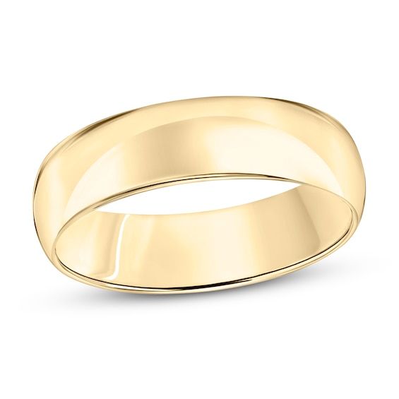 a plain wedding ring in yellow gold, with a slight edge and slightly domed surface