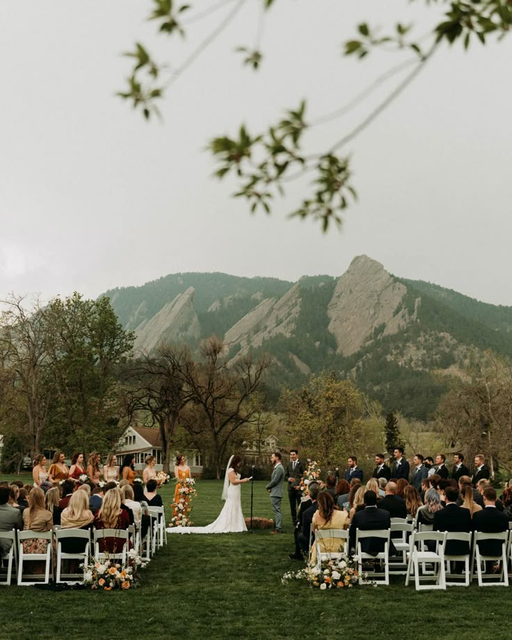 an outdoor wedding ceremony in the mountains