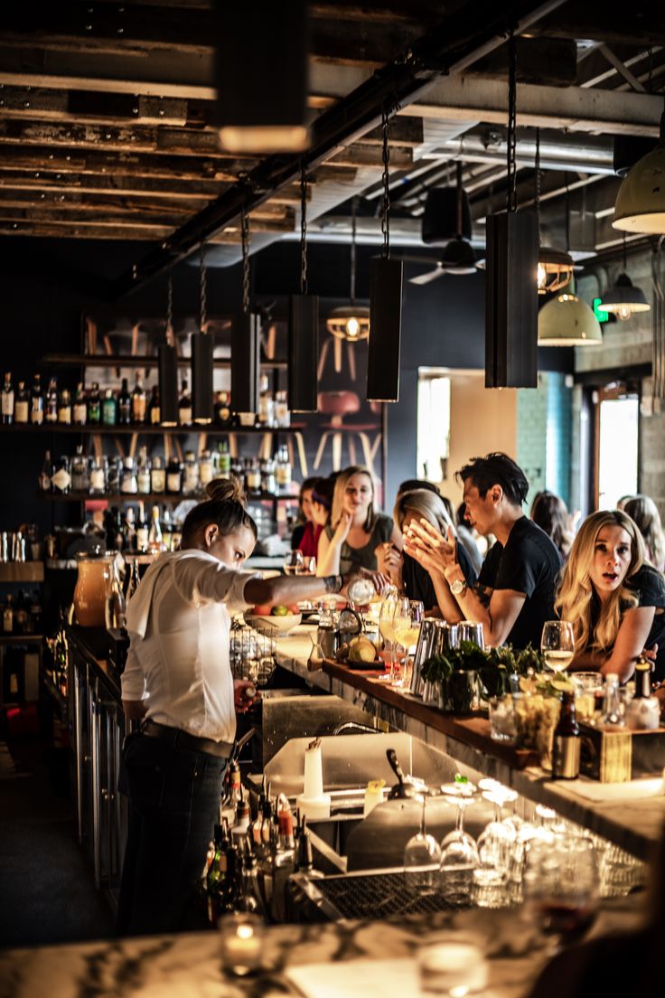 a group of people sitting at a bar