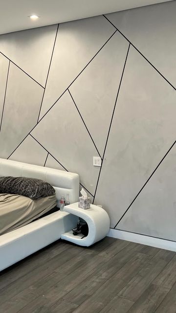 a modern bedroom with white and grey walls