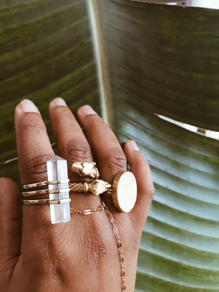 "A small Quartz Crystal tower, also know as the \"Universal Crystal\" comes beautifully encased in a layered brass ring band. No two crystals are alike which makes this ring one of a kind for each owner. Each Crystal is about 1.25 inch in size. Quartz crystal is know to enhance energy, thoughts, harmonizing and balancing ones environment. It is also beneficial for manifesting, healing, meditation, protecting and channeling. DETAILS: 1.25\" Quartz Crystal (size may vary slightly) Brass Ring Band Heirloom Brass Jewelry For Everyday, Everyday Gold Brass Midi Rings, Stackable Brass Jewelry As Gift, Gold Brass Crystal Ring For Gifting, Gold Brass Crystal Ring Gift, Stackable Brass Jewelry Gift, Adjustable Heirloom Brass Jewelry, Heirloom Brass Open Ring Jewelry, Spiritual Hand Forged Brass Rings