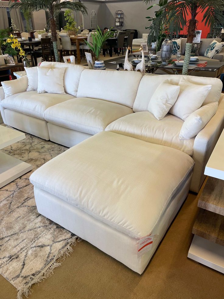 a large white sectional couch in a store