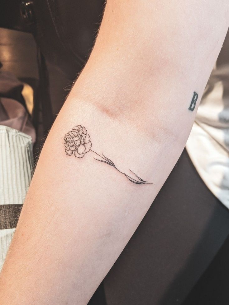 a person with a flower tattoo on their arm