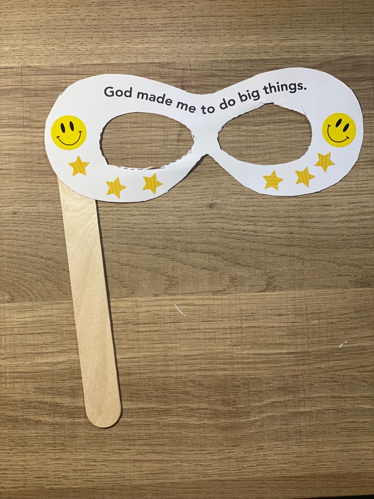 a wooden stick with a white mask on it that says god made me to do things