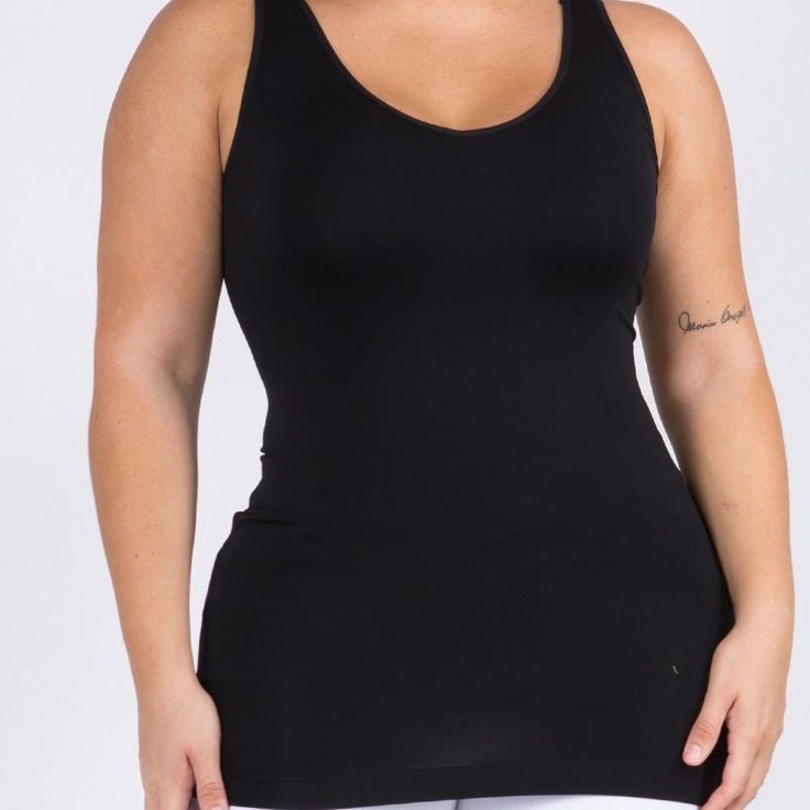 This Seamless Tank Makes Styling Any Outfit A Breeze! Featuring A V-Neckline And Fitted Silhouette In A Buttery, Soft Fabric That's Very Comfortable For Wearing All Day. Wide Shoulder Straps V-Neckline Back Scoop Neck Fitted Silhouette Seamless Design Buttery Soft Fabrication With Stretch Pull On/Off Longline Hem 92% Nylon, 8% Spandex Black Camisole With Built-in Bra For Layering, Black Seamless Tops With Built-in Bra, Solid Stretch Shapewear Tops, Seamless Shapewear Top In Solid Color, Shapewear Top With Built-in Bra And Stretch, Stretch Shapewear Top With Built-in Bra, Solid Color Shaping Tank Top, Seamless Stretch Camisole For Layering, Stretch Camisole For Layering With Seamless Construction