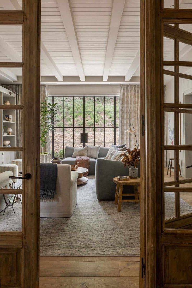 a living room filled with furniture and lots of windows