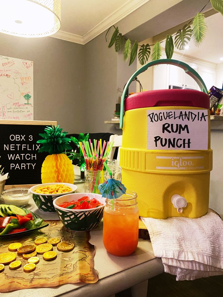 a table topped with lots of food and drinks next to a sign that says yogurt maniana rum punch