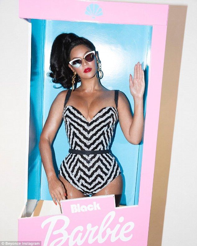 a woman in a black and white bathing suit is holding a sign that says barbie