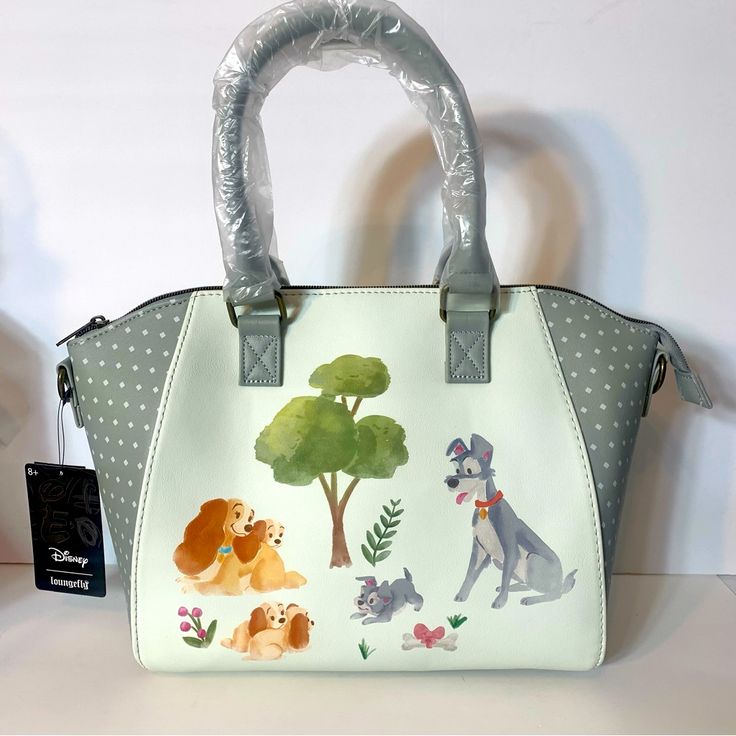 Nwt. Loungefly Lady And The Tramp Disney Watercolor Satchel Or Crossbody Bag. Faux Leather Shell, With Fabric Interior Lining. Front Zipper Pocket. Adjustable Shoulder Straps. Top Carry Handles. Approx. 9”H X 10.5l X 4.5”W. Adjustable Detachable Crossbody Strap, Interior Drop Pocket And Top Zipper Closure. Adorable Pics Of Lady And The Tramp With Their Puppies. Green Disney Bags For Everyday Use, Green Disney Style Bags For Daily Use, Disney Bags For Daily Use, Daily Disney Style Bag, Disney Satchel Bag For Everyday Use, White Disney Bags For Everyday Use, White Disney Everyday Bag, White Disney Style Bag, Disney Style White Everyday Bags