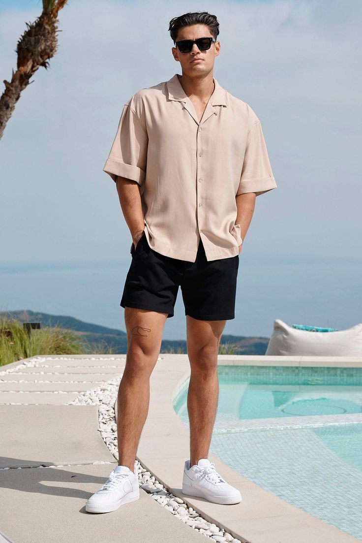 MATERIAL: 50% Cotton, 45% Polyester, 5% Spandex. FIT: True to Size. DESIGN: These shorts are perfect for a summer vacation, whether you're lounging on the beach or exploring a new city. They come in a variety of colors and styles to suit any outfit, from classic khaki to pure white. Pair them with the 468 shirt for a dressier look, or with a YoungLA tee for a more casual vibe. MODEL: The model in the first photo is wearing a size Medium. Weight: 175lb Height: 5'9. Shirt With Shorts Outfits Men, Men’s Casual Vacation Outfit, Summer Dinner Men’s Outfit, Men's Casual Outfits Summer, Europe Trip Outfits Men, Mens Shorts Outfits Formal, Classic Men Outfit Summer, Shorts Men’s Fashion, Beach Style Men Summer