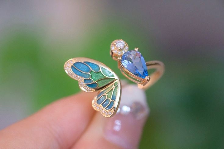 "Introducing our stunning Aquamarine Butterfly Ring - the perfect anniversary gift for that special someone or a lovely treat for yourself. 🦋💍 100% High-quality Natural Aquamarine Gemstones  💎100% High-quality Natural Diamonds 💎  ----------------------♡-------------------- Ring Setting: ●Main stone: 1.0 ct Natural Aquamarine Gemstone ●Material: 18k Gold ●Free Jewelry Certification: A globally recognized certification will come with this fine gem jewelry ●Packaging: All items are nicely packaged ready to gift in elegant jewelry boxes ----------------------♡-------------------- Important Note: ●Since every piece of jewelry is unique and made-to-order for you, the sizes of stones and metal weights may vary slightly. ----------------------♡-------------------- Processing & Free Shipping: ● Luxury Enamel Gemstone Ring For Gift, Luxury Enamel Rings Perfect As Gifts, Luxury Enamel Ring As Gift, Luxury Enamel Rings As Gift, Diamond Enamel Gemstone Ring Gift, Diamond Enamel Ring With Gemstone For Gift, Blue Enamel Ring With Polished Finish As Gift, Blue Enamel Ring With Polished Finish For Gift, Fine Jewelry With Unique Design As A Gift