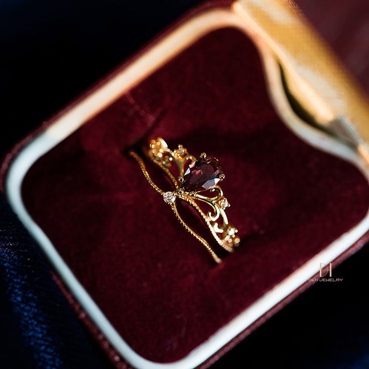 a gold ring sitting on top of a velvet case