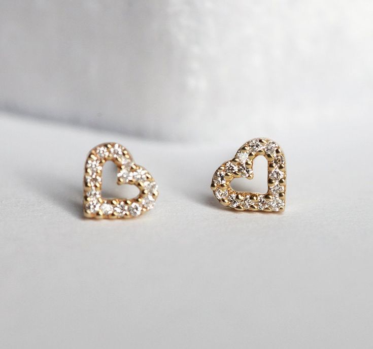 DELICATE DIAMOND HEART-SHAPED GOLD STUD EARRINGSA cute pair of diamond heart earrings. Perfect as a gift for a special lady in your life: your mom, sister, friend or yourself. If you would prefer custom earrings, please contact us before purchase.DETAILSMain Stone  Stone: Diamond  Shape: Round  Color: White  Measurements: 1mm Band  Style: Stud  Material:  14k Gold: yellow, white, rose  18k Gold: yellow, white, rose  Other Metal: platinum   Sizing: We are using US metric system Customization Opti Diamond Heart Earrings, Diamond Earrings Wedding, Gold Body Chain, Flawless Diamond, Aquamarine Engagement Ring, Buy Earrings, Earrings Diamond, Heart Shaped Diamond, Custom Earrings