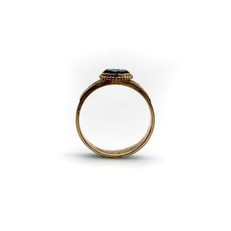 This is part of Chairish’s Fine Jewelry assortment.  This delicate and dear 14k gold ring combines some of the most enticing qualities of Victorian mourning jewellery. In its centre is a banded agate disc carved with a quatrefoil design. The agate contains two shades of blue that create an intricate X-shaped floral graphic symbol. A circular ball motif of 14k gold frames the disc, and on either side is a hand-engraved scrolling foliate of leaves. The bottom of the band features a vibrant turquoi 14k Gold Oval Enamel Ring For Formal Occasions, Oval 14k Gold Enamel Ring For Formal Occasions, Formal Oval Enamel Ring In 14k Gold, Formal Oval 14k Gold Enamel Ring, Timeless 14k Gold Emerald Ring With Rose Cut Diamonds, 14k Gold Opal Ring With Rose Cut Diamonds, Heirloom Halo Ring With Round Band, Heirloom Halo Round Ring, Heirloom Sapphire Ring With Halo In 14k Gold