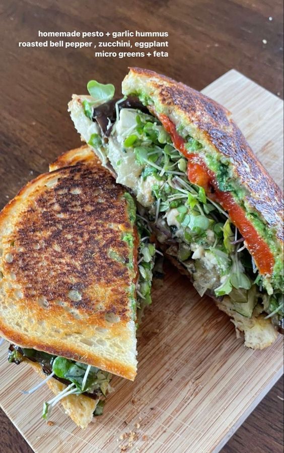 a grilled sandwich cut in half on a cutting board