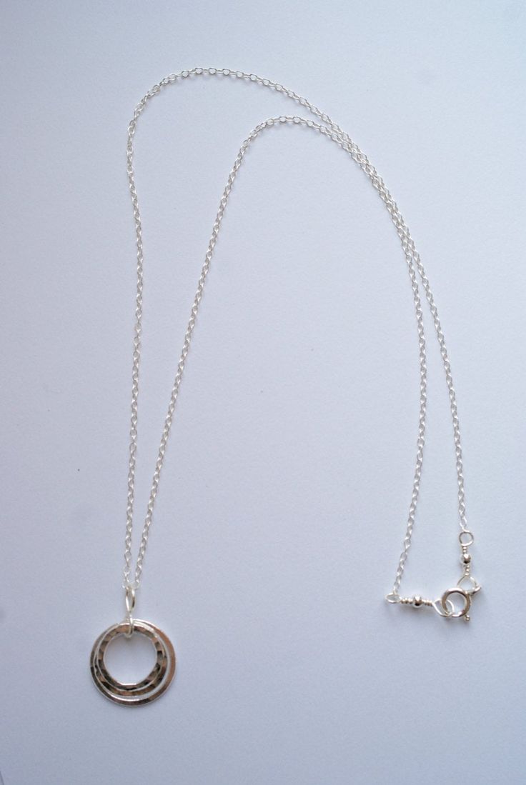 This lovely necklace will bring a simple style and elegance to any outfit. Three circles necklace, each circle is a different size. One circle is slightly large then the next. These circles are hand formed and then fused together. The smallest and middle sized circles are hammered to bring a shimmer to the charm - the largest of the three circles is a flat finish. Each circle is made from a heavy gauge fine silver (99.9% silver). The pendant measures about 1 inch. The necklace is a sterling silv Everyday Sterling Silver Round Charm Necklaces, Everyday Round Sterling Silver Charm Necklace, Classic Circular Sterling Silver Jewelry, Simple Silver Cable Chain Jewelry, Simple Silver Jewelry With Cable Chain, Round Charm Necklaces With Cable Chain For Anniversary, Silver Charm Necklace For Everyday, Delicate Silver Charm Necklaces, Round Charm Necklace With Cable Chain For Anniversary