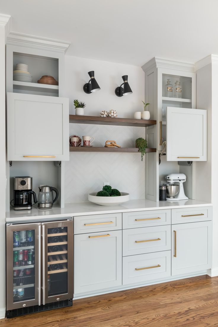 a kitchen with white cabinets and stainless steel appliance on the wall above it