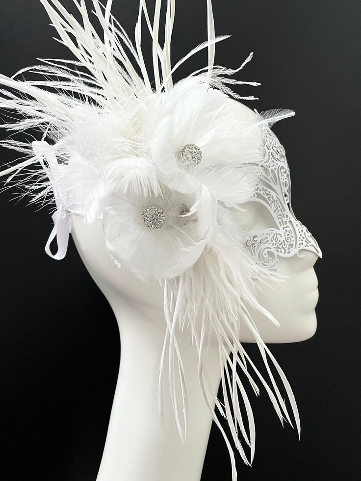 Simplistic for woman with a white flower- destined to pop out at any event, wedding etc The white metal women mask is flower decoration with feather and blossoming branches. This masquerade mask is great for any occasion. White Formal Masquerade Mask For Carnival, Elegant White Masquerade Mask For Weddings, Elegant White Wedding Masquerade Mask, Elegant White Masquerade Mask For Carnival, Elegant Wedding Masquerade Mask Adjustable, Elegant Adjustable Masquerade Mask For Wedding, Elegant Adjustable Wedding Masquerade Mask, Adjustable Masquerade Mask For Wedding Carnival, Adjustable White Headpiece For Carnival