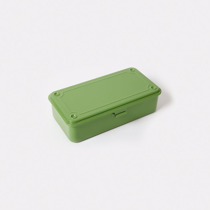 a green box sitting on top of a white surface