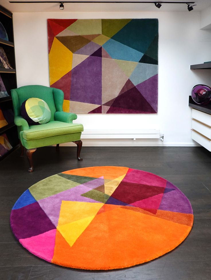 a brightly colored rug is in front of a chair