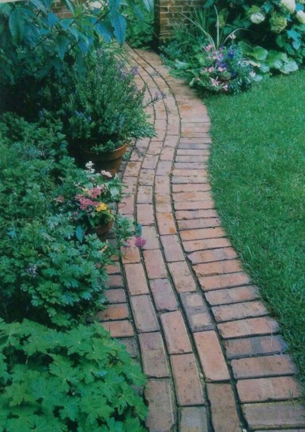 a brick path in the middle of a garden