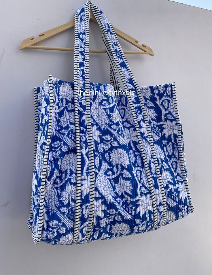 cotton print Bag The Indian Hand Block Printed Cotton Quilted Women's Handbags from Rajasthan India. This Handbag is completely Indian Printed on good quality cotton. Cotton quilted Jhola Bag made by Indian Artisans, this cotton quilted shopping bag is totally unique and multi purpose. Use this for your grocery or as a travel bag. Perfect to suit all. Item :- Cotton Handbag Material: Quilted Cotton Fabric Color - rainbow Pattern : Block Print Style: Tote Bag, Handle Bag, Shoulder Bag Size in Inch:- Height-18" inch Width- 19" inch Handle-13" inch Product Work: Printed & quilted Stitched Usage : Cosmetic, Make-up, Travel, Toiletries, Medicine, Accessories, Shopping and much more. Perfect for Beach Visits/ Quick Grocery runs/ Carrying Kids items/ Artist Paint book and Paints /Extra Bag Washab Rectangular Cotton Summer Bag, Summer Rectangular Cotton Bag, Vacation Cotton Tote Shoulder Bag, Cotton Shoulder Beach Bag, Cotton Shoulder Bag With Double Handle For Vacation, Blue Cotton Canvas Bag For Vacation, Bohemian Blue Canvas Bag For Everyday Use, Rectangular Cotton Canvas Beach Bag, Handmade Blue Canvas Bag For Daily Use