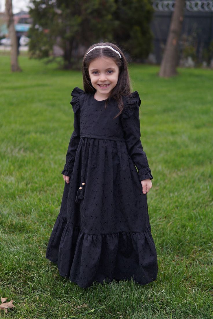 Kids Hijab Dress Almila Model Black Product Features   Fabric Feature: It is made of scalloped cotton fabric. It can be used in 4 seasons. Product Features : It is produced with Almila model festoon cotton fabric. The interior is fully lined with cotton. The front is threaded. Her shoulders are ruffled. It has a hidden zipper on the back. The sleeves are rubber. Note: This product is Black in color. If you are looking for a different color, visit our Etys store.  https://www.etsy.com/shop/Mevlan Kids Eid Dress, Kids New Model Dress, Solid Long Sleeve Dresses For Eid, Long Sleeve Solid Dress For Dress-up, Solid Color Long Sleeve Dress For Dress-up, Solid Long Sleeve Dress For Dress-up, Modest Black Dress For Eid, Black Modest Dress For Eid, Black Long Sleeve Dresses For Eid