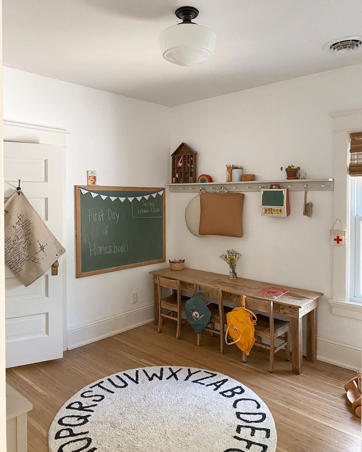 a child's room with a chalkboard and wooden toys on the floor in front of it