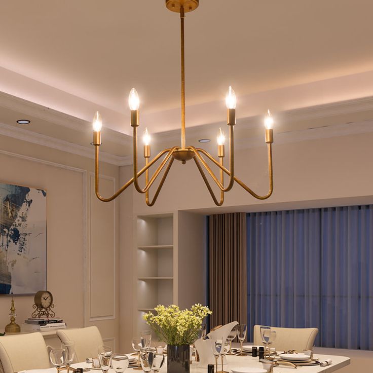 the dining room table is set with place settings for four people and has a chandelier