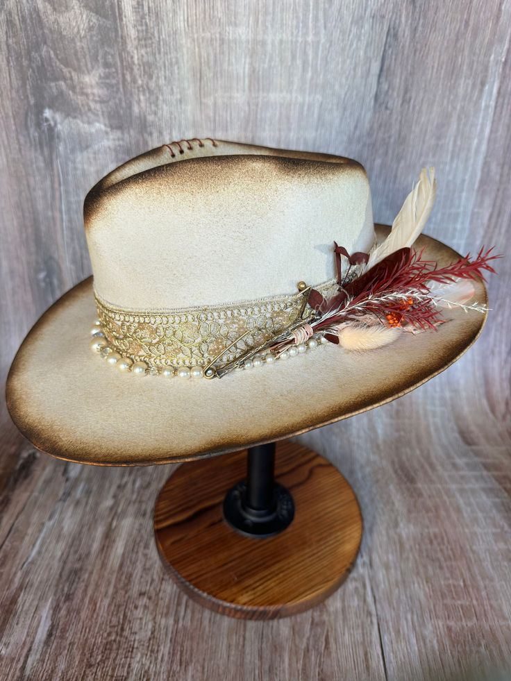 This gorgeous soft brim wool fedora shines with elegance. It's torched to perfection. It has gold accents and a pearl beaded band. It has an adjustable drawstring inner band to fit most size heads. Luxury Brimmed Fedora For Fall, Elegant Brown Felt Hat For Western-themed Events, Elegant Flat Brim Fedora For Western-themed Events, Elegant Fedora For Western-themed Events, Elegant Fall Hat Bands For Western-themed Events, Elegant Brown Fedora For Country Events, Gold Wide Brim Fedora For Festivals, Elegant Flat Brim Hat For Festivals, Gold Fedora With Short Brim For Festivals