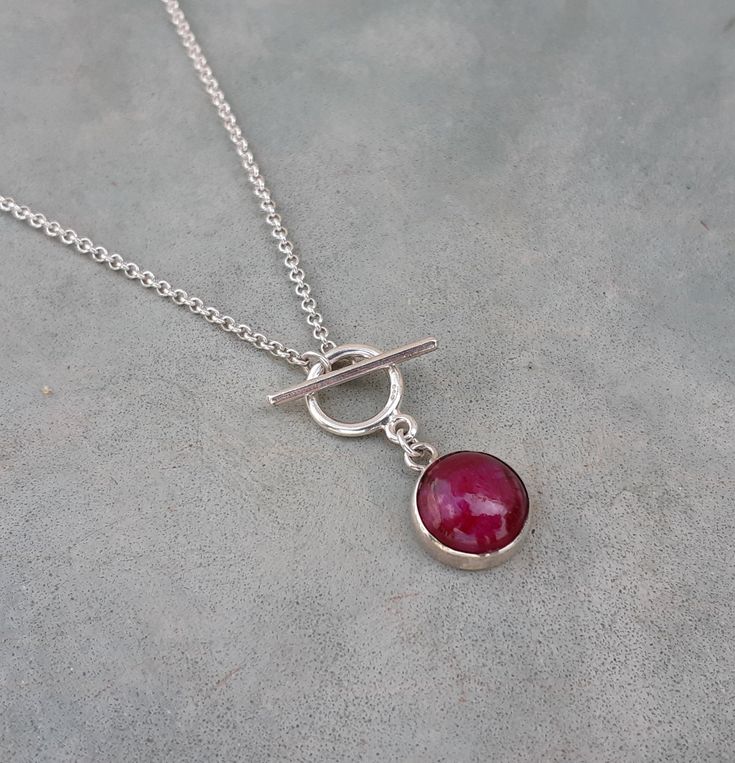 Minimalist ruby toggle necklace,ruby birthstone necklace,anniversary wife gift,ruby chocker Natural round 10mm opaque ruby cabochon set in a sterling silver bezel with a sterling silver cable chain It's simple and minimalist can be worn alone or layered with other necklaces The ruby is july birthstone, great birthday/anniversary wife gift for ruby lovers:) Measures : Ruby- 10mm Necklace length- please select Door to door shipping Elegant Toggle Necklace With Sterling Silver Clasp, Elegant Toggle Necklace With Sterling Silver Clasp As Gift, Ruby Cabochon Round Jewelry, Minimalist Ruby Jewelry As A Gift, Minimalist Ruby Jewelry As Gift, Minimalist Sterling Silver Toggle Necklace As Gift, Minimalist Sterling Silver Toggle Necklace, Adjustable Ruby Jewelry For Gifts, Elegant Sterling Silver Toggle Necklace As Gift