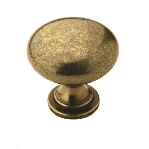 an antique brass cabinet door knob on a white background with clipping for text or image