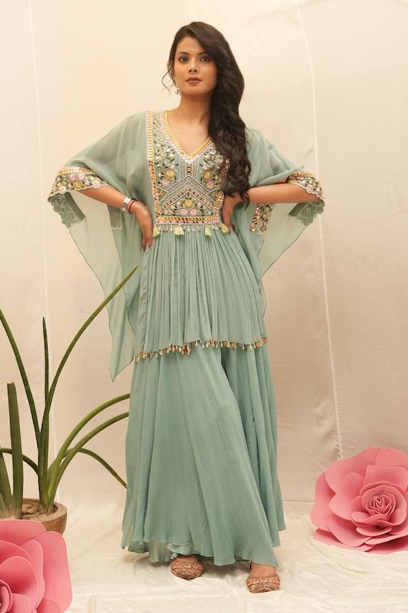 Topaz green kurta with thread embroidered floral jaal patterns, embellished by mirrorwork and pearl shell tassels. Comes with sharara. - Aza Fashions Eid V-neck Kurta With Intricate Embroidery, Traditional V-neck Sharara For Eid, Bollywood Style V-neck Sharara For Eid, Traditional V-neck Wedding Sets, Diwali V-neck Sharara With Resham Embroidery, Green V-neck Kurta With Resham Embroidery, Bollywood Style Embroidered V-neck Set, Festive V-neck Sets With Resham Embroidery, Green V-neck Sets For Eid