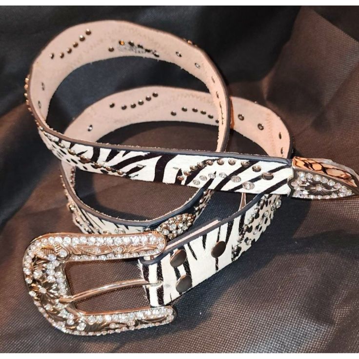 Elevate Your Outfit With This Striking Nocona Zebra Print Belt, Adorned With Rhinestones And Metallic Studs. The Elaborate Buckle Adds A Touch Of Glamour, Making It An Eye-Catching Addition To Any Wardrobe. Crafted For Those Who Appreciate Unique And Bold Fashion Statements, This Belt Promises To Be A Conversation Starter. Zebra Print Design Rhinestone And Metallic Stud Embellishments Elaborate Buckle Women's Fashion Accessory Adjustable Fit Western Bling, Fashion Statements, Rhinestone Studs, Suspender Belt, Buckle Belt, Bold Fashion, Zebra Print, Bling Bling, Belt Buckles