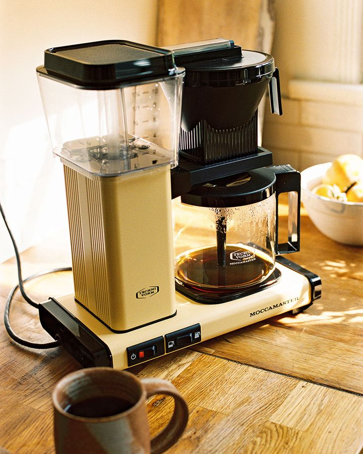 a coffee maker sitting on top of a wooden table