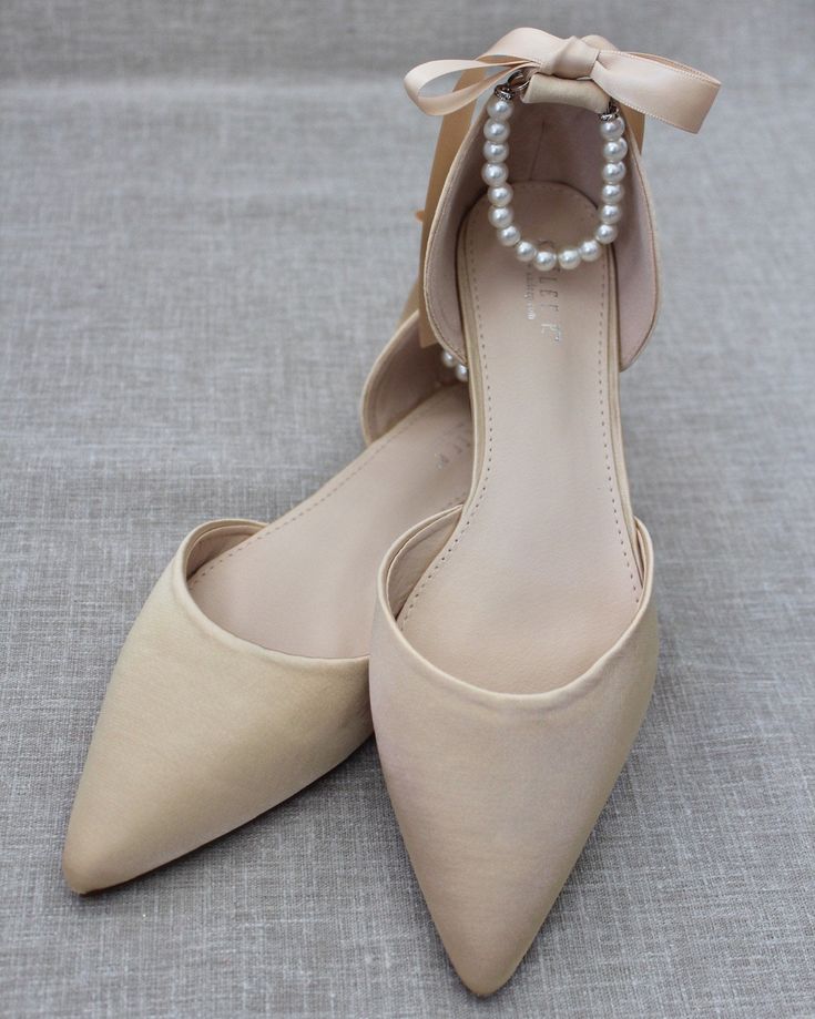 "Satin pointy toe flats with beautiful row of pearls as ankle strap. Comfortable throughout your special day and perfect for holiday party, night out and wedding party. YOU CAN CHOOSE THE PEARLS ANKLE STRAP AT CHECKOUT Details: COLORS AVAILABLE: Black, Blush, Burgundy, Champagne, Light Blue, Navy, Red, Royal Blue, Ivory, and White UPPER: Synthetic upper and lining MATERIALS: Mandmade outsole STYLE NAME: BELLA SIZE FIT: RUNS LARGE, ORDER HALF SIZE DOWN FROM YOUR NORMAL SIZE Not sure of which size Elegant Pointed Toe Flats With Ankle Strap For Wedding, Elegant Wedding Pointed Toe Flats With Ankle Strap, Elegant Pointed Toe Flats For Bridesmaids, Elegant Pointed Toe Bridesmaid Flats, Elegant Closed Toe Bridesmaid Flats, Elegant Bridesmaid Closed Toe Flats, Fall Wedding Shoes, Black Blush, Bridal Flats