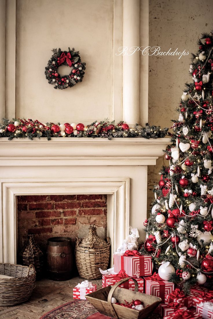 a decorated christmas tree in front of a fireplace