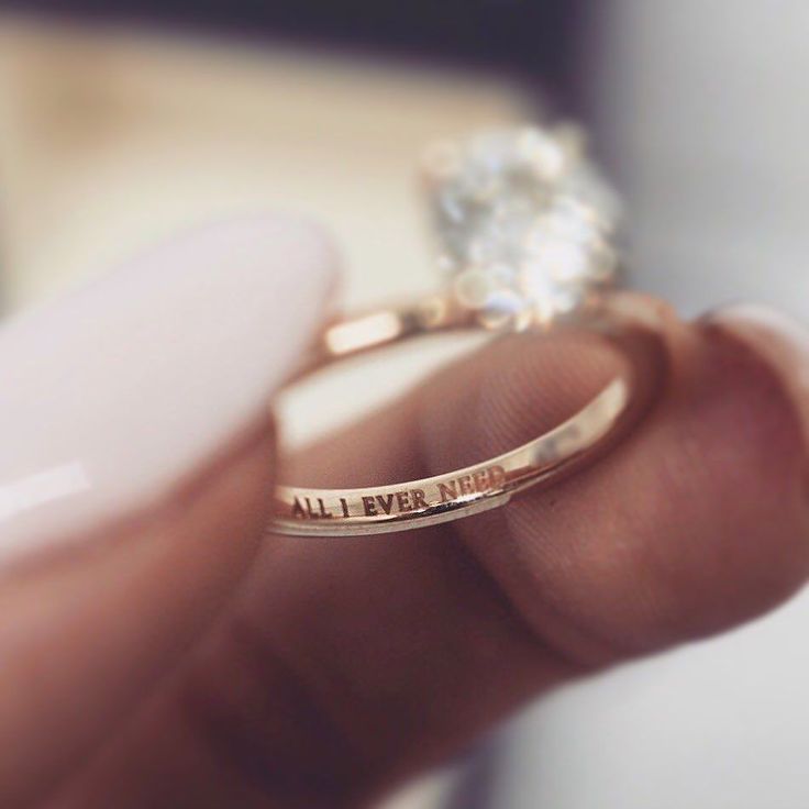 a woman's hand holding a diamond ring with the words, all i ever need is you