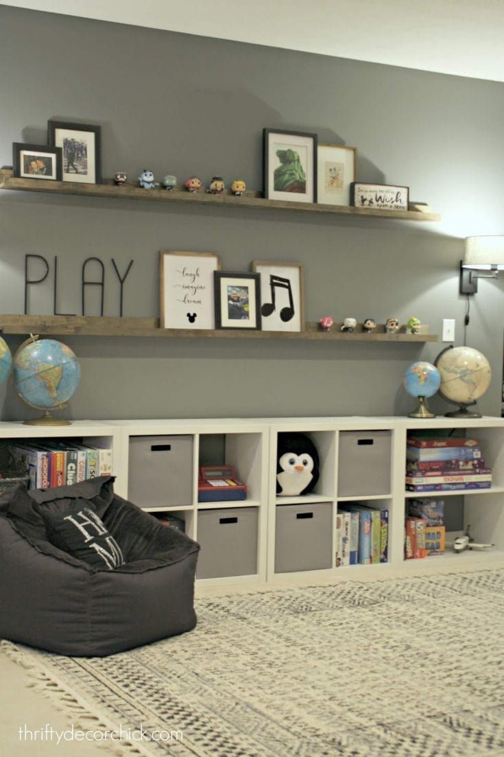 a living room filled with lots of furniture and bookshelves on top of shelves