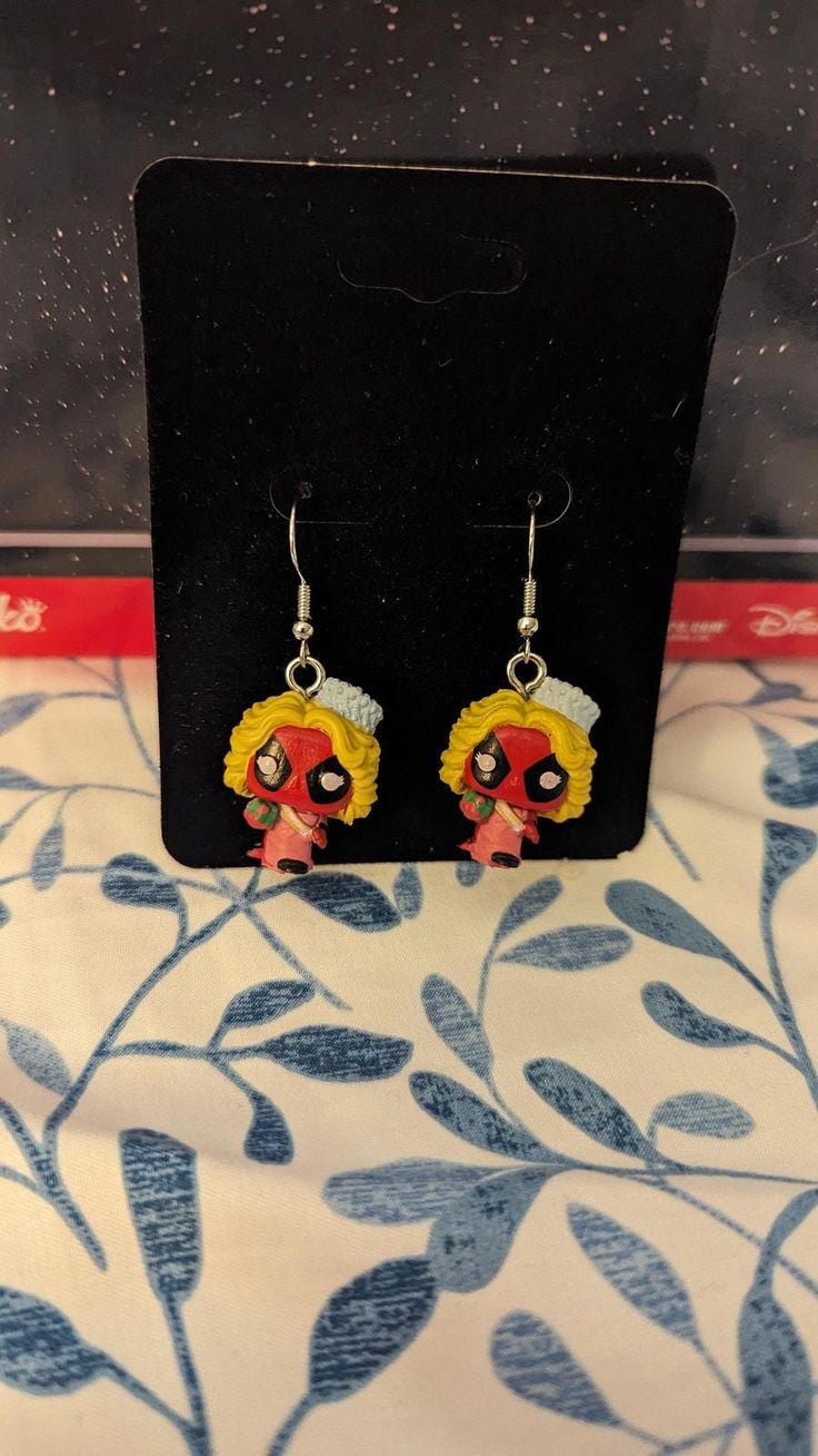 These are Funko Bitty Pops turned into earrings.  They still fit in their box and can be worn with or without the base on them.    (the base does have a very tiny screw that holds it on the Bitty Pop!. They weigh approximately 2 grams each without the base and 3 grams with the base.  Each purchase is for 1 pair.  Matching Characters. Themed Earrings For Pierced Ears As Gift, Themed Pierced Earrings As A Gift, Themed Gift Earrings, Themed Dangle Earrings, Themed Dangle Pierced Earrings, Themed Red Earrings, Nickel-free Themed Dangle Earrings, Themed Adjustable Earrings With Ear Wire, Adjustable Themed Earrings With Ear Wire