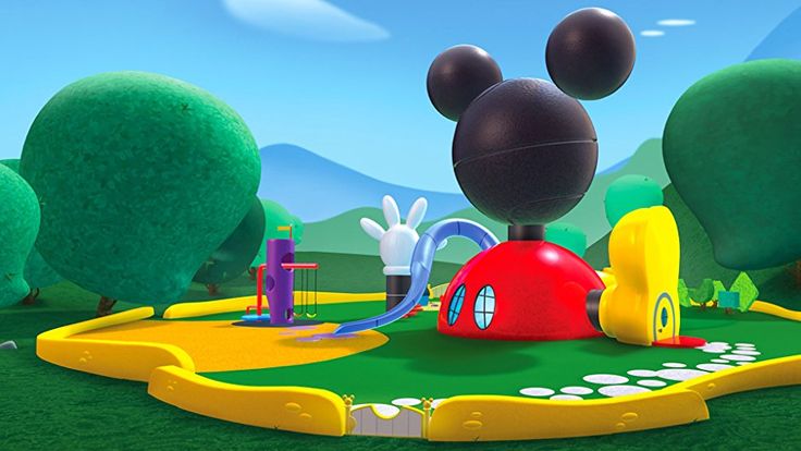 mickey mouse's golf course with trees and mountains in the background