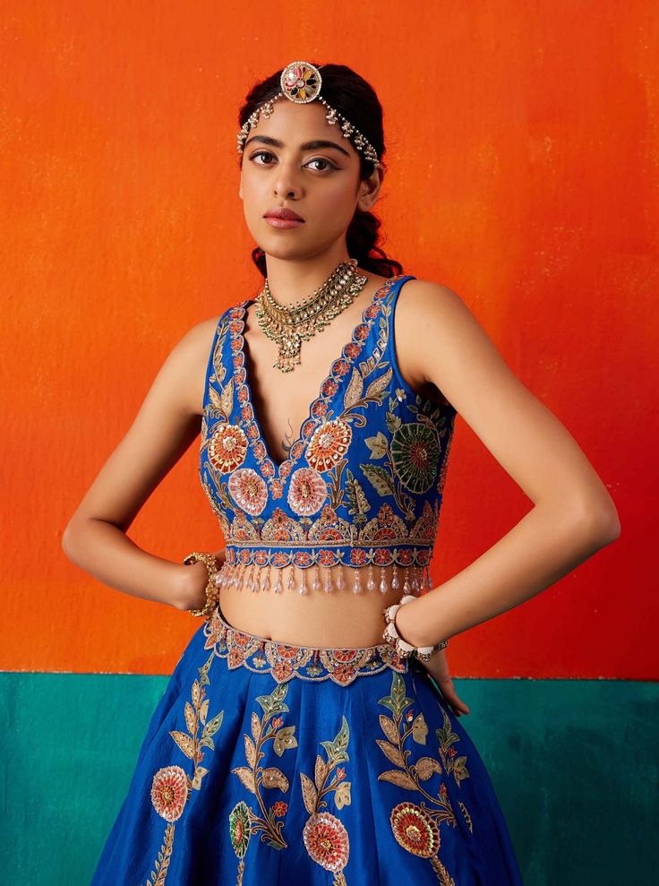 Make a bold statement in this electric blue lehenga set, adorned with floral thread embroidery highlighted by various embellishments. The set is paired seamlessly with an embroidered blouse and dupatta, creating a stunning ensemble that exudes vibrancy and sophistication, perfect for special occasions. Cobalt Blue Lehenga, Blue Semi-stitched Palazzo Set For Reception, Semi-stitched Blue Palazzo Set For Reception, Designer Blue Dola Silk Palazzo Set, Blue Anarkali Dola Silk Palazzo Set, Blue Anarkali Style Dola Silk Palazzo Set, Blue Palazzo Set For Reception And Festivals, Blue Festive Palazzo Set For Reception, Blue Anarkali Palazzo Set For Reception