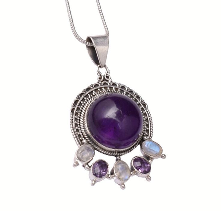 FAST SHIPPING HASSLEFREE RETURNS SECURE PAYMENT EXCELLENT SERVICE Product Description Product Details   Jewelry Type: Fine Metal: 925 Sterling Silver Style: Fine Jewelry Pendant Chain Type : Without Chain Gemstone: Amethyst & Moonstone Gemstone Shape: Round Cabochon Gemstone Setting: Bezel Finished with: Rhodium Polished Dimension: Length 1.67 in x Height 0.89 in x Width 0.59 in SHIPPING Shipping 1. International Standard – 14-21 days a. For United States of America, United Kingdom and Australia – Free shipping b. For Canada and Europe - $4.99 c. Rest of the world - $6.99   2. International Expedited – 5-10 days a. For United States of America – $9.99 b. For Canada and Europe - $14.99 c. Rest of the world - $17.99 PAYMENT Payment 1. We preferred payment through PayPal. It is one of the saf Spiritual Purple Cabochon Jewelry, Purple Gemstone Amulet Necklace, Purple Multi-stone Pendant Necklace, Purple Round Multi-stone Jewelry, Purple Amethyst Amulet Jewelry, Purple Multi-stone Pendant Gemstones, Purple Multi-stone Pendant Jewelry, Amethyst Pendant Gemstones With Accents, Amethyst Gemstone Necklace With Round Stone