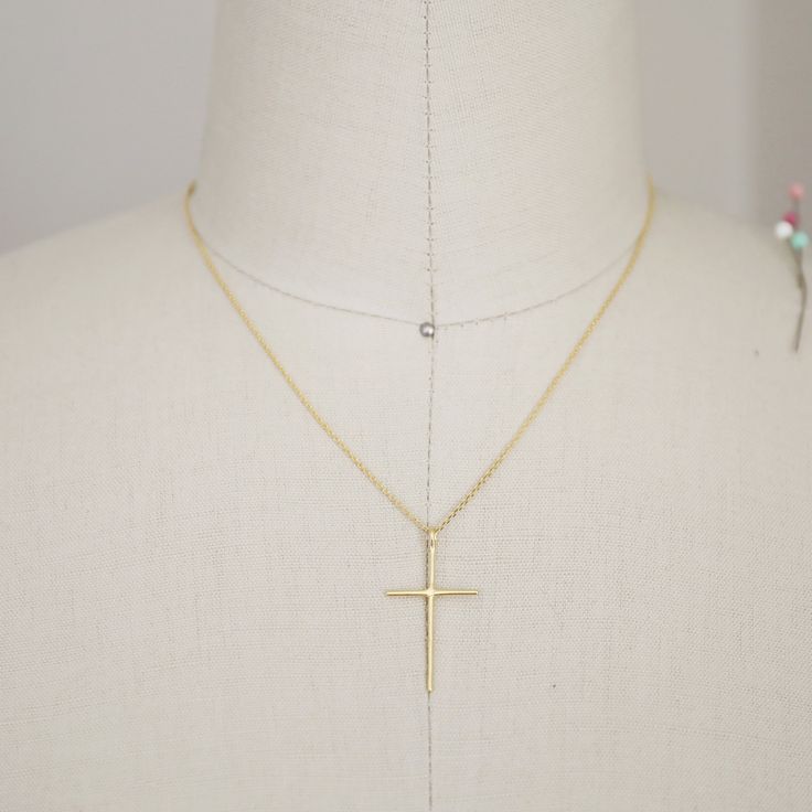 "Beautiful and lovely tiny gold color necklace featuring skinny gold cross pendent. Lobster clasp closure. Simple and warm. Gold plated brass necklace is perfect paired with any outfit . Your beautiful necklace will ship in a gift box. If you have any question, please feel free to contact me. Thanks :) ♥ Length 16\" chain ( if you need different length please contact us ) ♥ Cross pendent 1 1/4\" x 3/4\" ♥ Gold plated over brass ♥ Delivery Time Fast shipping within 1 - 3 days + See more Rudiana A Gold Cross Charm Necklaces In 14k Gold Filled, Gold Cross Necklace With Delicate Chain For Everyday, Everyday Gold Cross Necklace With Delicate Chain, Gold Cross Necklace For Everyday, Simple Gold Cross Necklace As A Gift, Everyday Gold Cross Necklace, Everyday Yellow Gold Cross Charm Necklace, Gold Cross Charm Necklace In 14k, Gold Crucifix Charm Necklace In Minimalist Style