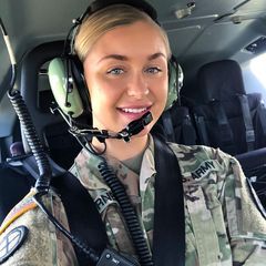 a woman in the cockpit of an airplane wearing a headset