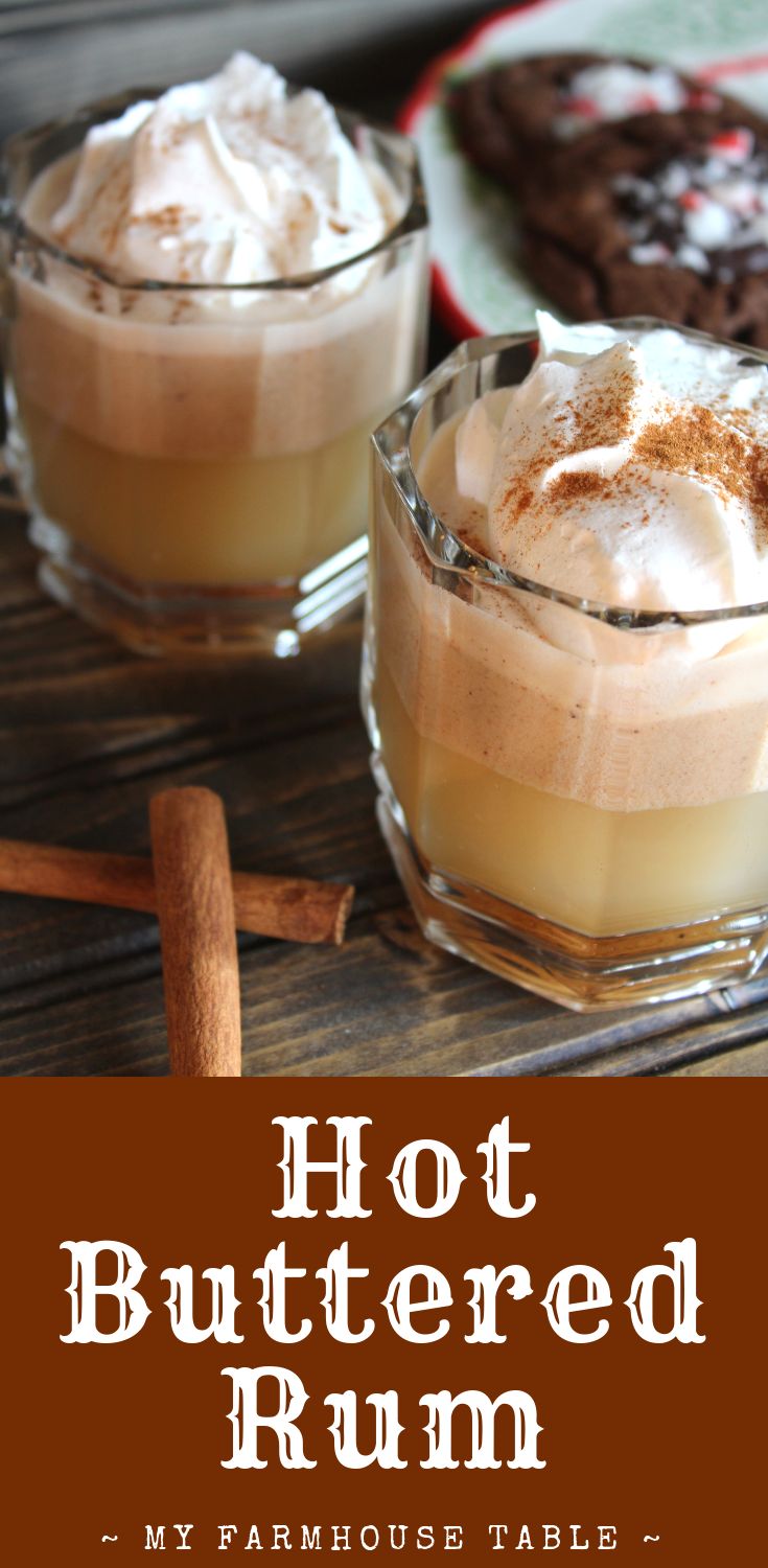 hot buttered rum with whipped cream and cinnamon on the rim in two small glasses